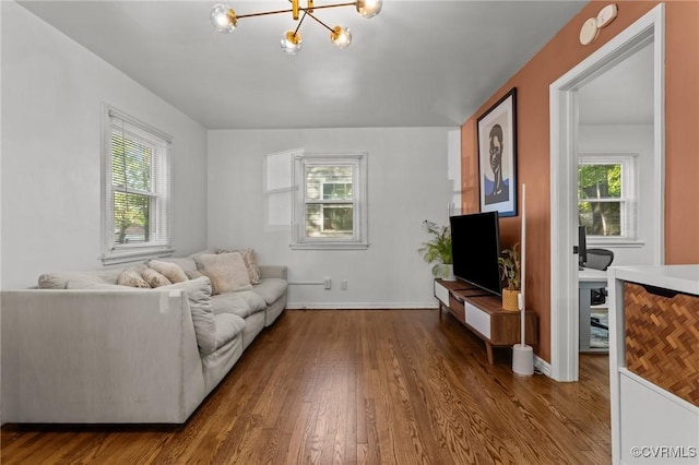 1712 Halifax Ave, Richmond, VA 23224 - living area featuring dark wood-style flooring, baseboards, a chandelier, and a wealth of natural light