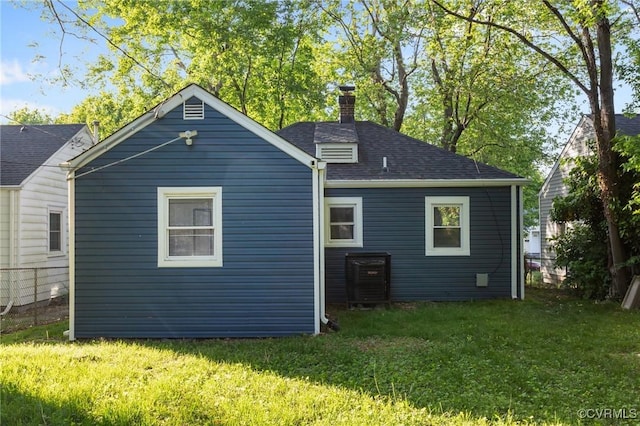 1712 Halifax Ave, Richmond, VA 23224 - back of house with a lawn, a chimney, and a shingled roof