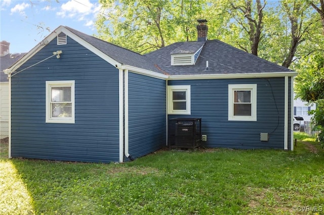 1712 Halifax Ave, Richmond, VA 23224 - rear view of house featuring roof with shingles, a yard, and a chimney