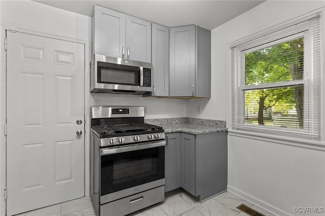 1712 Halifax Ave, Richmond, VA 23224 - kitchen featuring baseboards, marble finish floor, gray cabinets, and stainless steel appliances