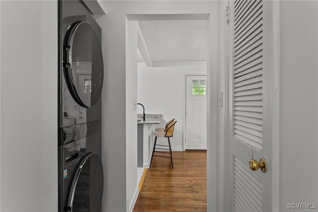 1712 Halifax Ave, Richmond, VA 23224 - laundry area featuring baseboards, laundry area, stacked washer / dryer, and wood finished floors