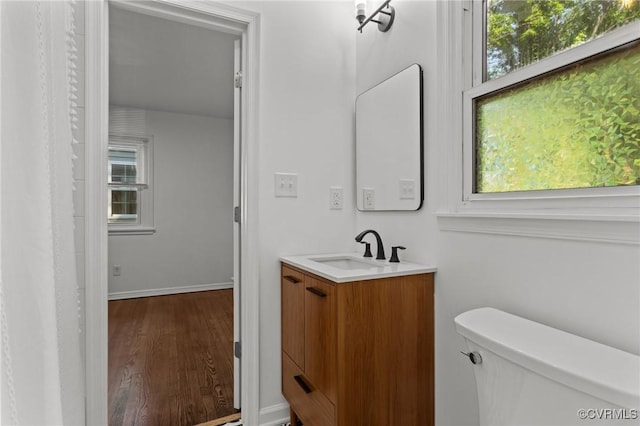 1712 Halifax Ave, Richmond, VA 23224 - bathroom with vanity, baseboards, toilet, and wood finished floors