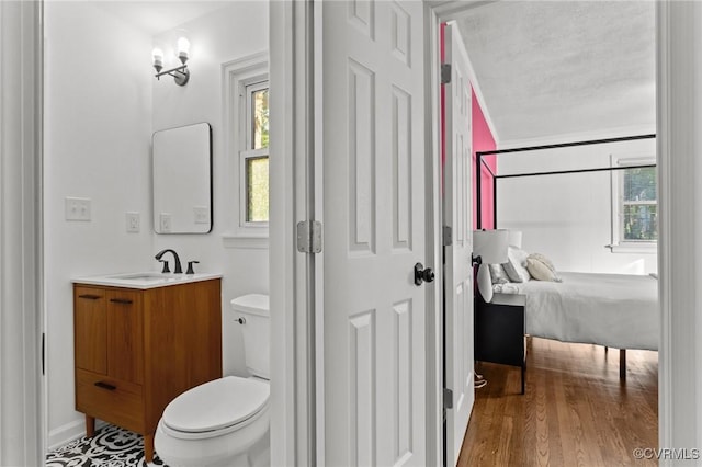 1712 Halifax Ave, Richmond, VA 23224 - bathroom featuring vanity, ensuite bath, wood finished floors, and toilet