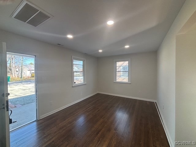 unfurnished room featuring baseboards, recessed lighting, dark wood finished floors, and visible vents