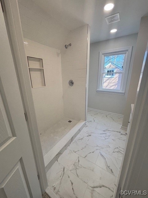 full bathroom with marble finish floor, recessed lighting, baseboards, visible vents, and tiled shower