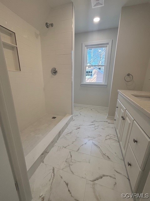full bathroom with visible vents, a tile shower, vanity, baseboards, and marble finish floor