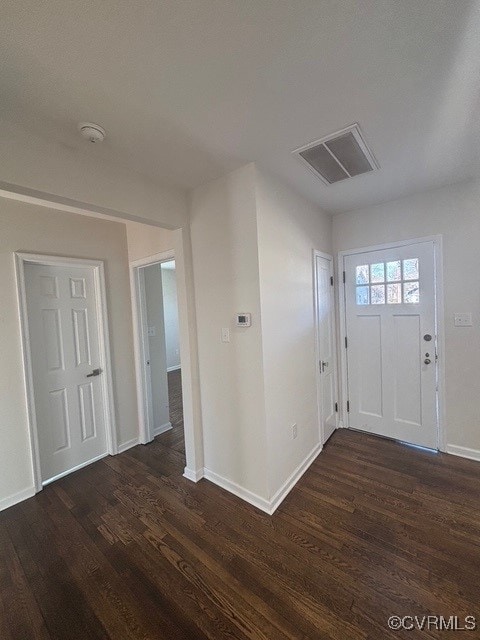 foyer with baseboards, dark wood-style floors, and visible vents