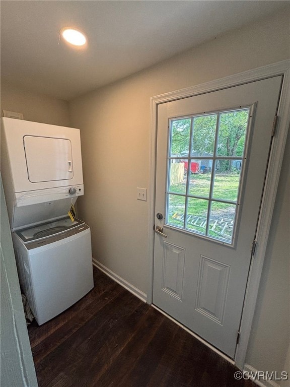 laundry room with recessed lighting, baseboards, stacked washer and clothes dryer, and dark wood finished floors