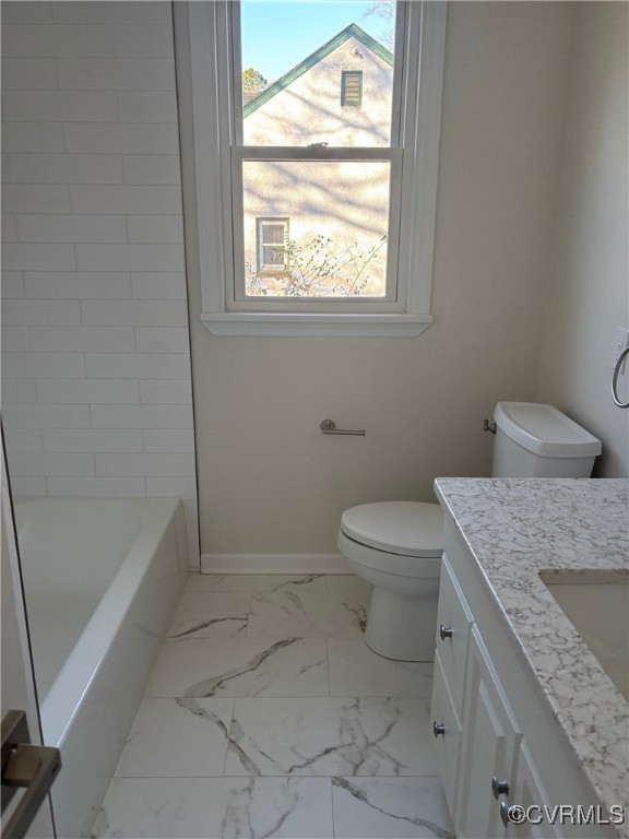 1409 Virginia Ave, Glen Allen, VA 23060 - bathroom featuring toilet, a bathing tub, baseboards, marble finish floor, and vanity