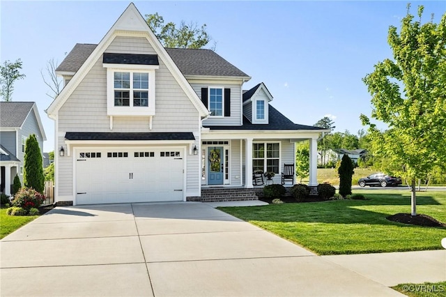 craftsman-style home featuring a garage, a front lawn, covered porch, roof with shingles, and concrete driveway