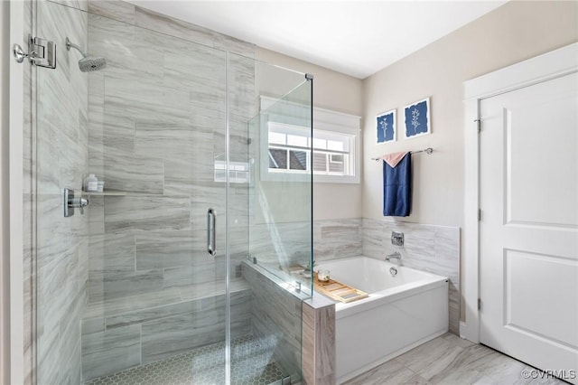 bathroom with marble finish floor, a shower stall, and a bath