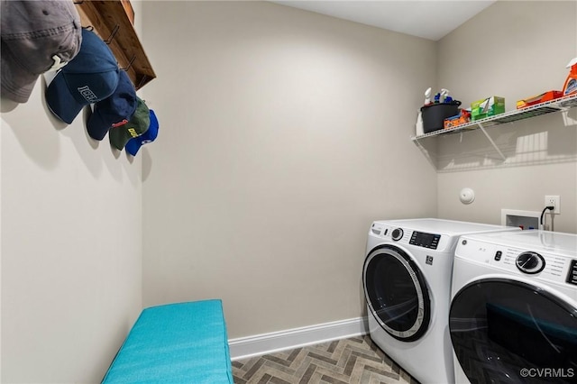 laundry area with baseboards, laundry area, and washer and dryer