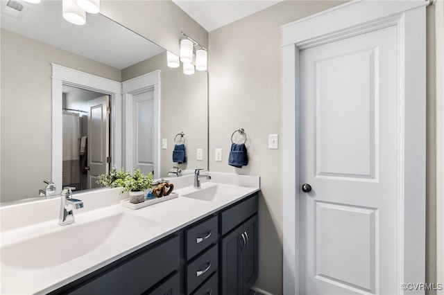 full bathroom with visible vents, a sink, and double vanity