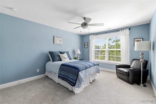 carpeted bedroom featuring baseboards, ceiling fan, and visible vents