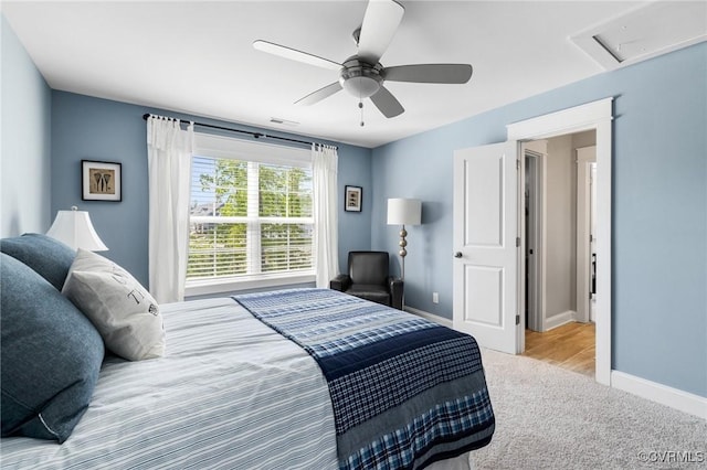 carpeted bedroom with a ceiling fan, baseboards, and visible vents