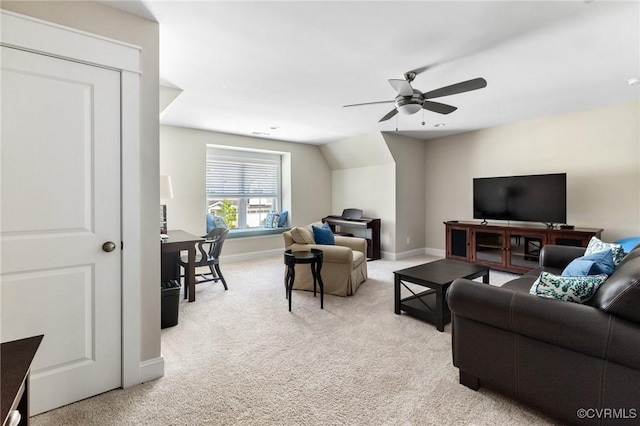 carpeted living area featuring baseboards, ceiling fan, and vaulted ceiling