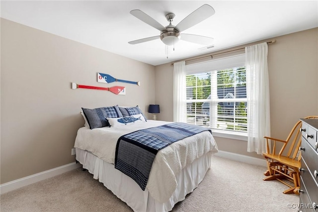 bedroom featuring baseboards, ceiling fan, light carpet, and visible vents