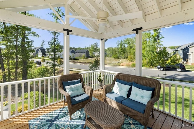 wooden deck featuring a residential view, a ceiling fan, and covered porch