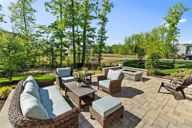 view of patio / terrace featuring a fenced backyard and an outdoor living space with a fire pit