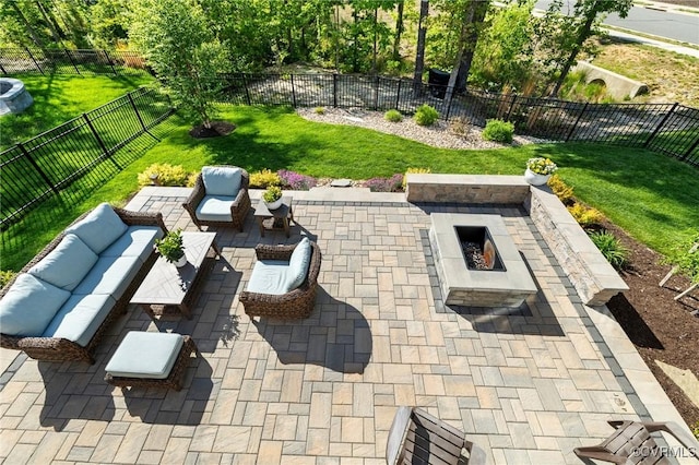 view of patio / terrace with a fenced backyard and an outdoor living space with a fire pit