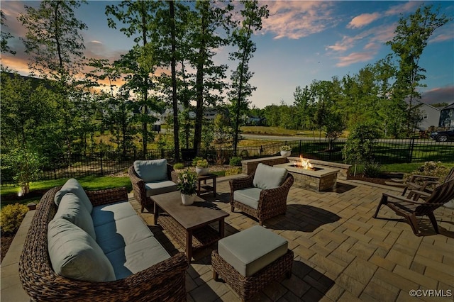 view of patio with a fenced backyard and an outdoor living space with a fire pit