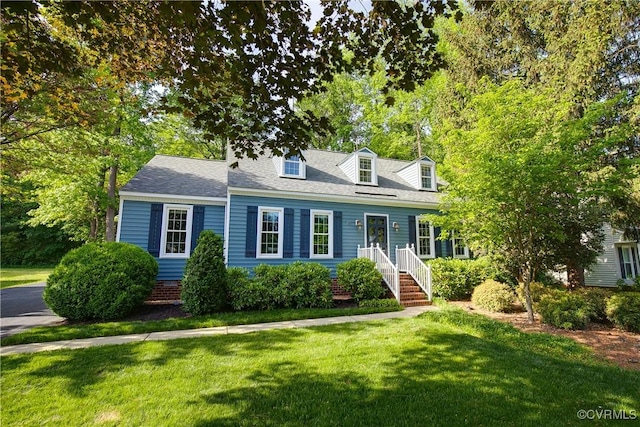 cape cod-style house with a front yard