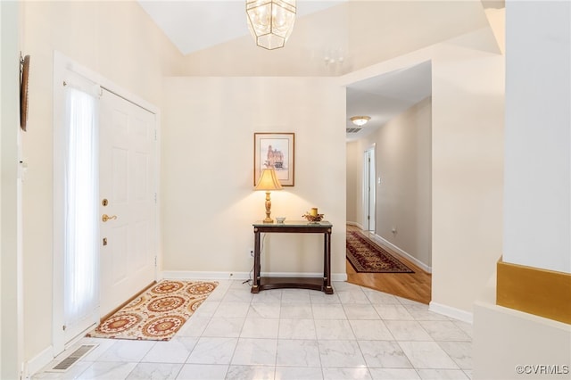 10932 Dominion Fairways Ln, Glen Allen, VA 23059 - entrance foyer with lofted ceiling, baseboards, marble finish floor, an inviting chandelier, and visible vents