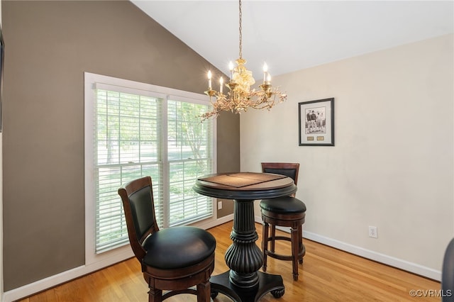 10932 Dominion Fairways Ln, Glen Allen, VA 23059 - dining area featuring baseboards, a notable chandelier, light wood finished floors, and high vaulted ceiling
