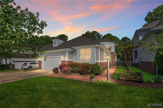 10932 Dominion Fairways Ln, Glen Allen, VA 23059 - view of front of property featuring a yard, driveway, brick siding, a garage, and roof with shingles