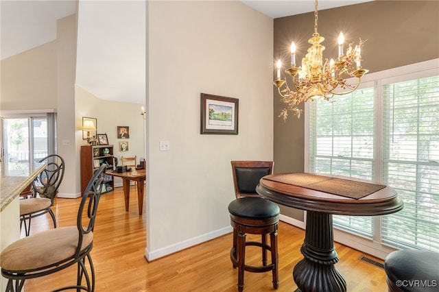 10932 Dominion Fairways Ln, Glen Allen, VA 23059 - dining space featuring high vaulted ceiling, visible vents, a chandelier, light wood-style flooring, and baseboards