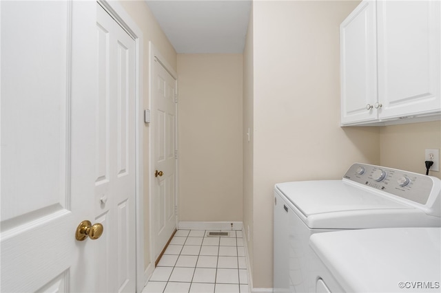 10932 Dominion Fairways Ln, Glen Allen, VA 23059 - clothes washing area with cabinet space, washing machine and dryer, light tile patterned floors, and baseboards
