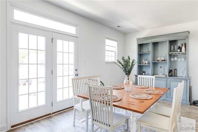 dining space featuring light wood-style flooring