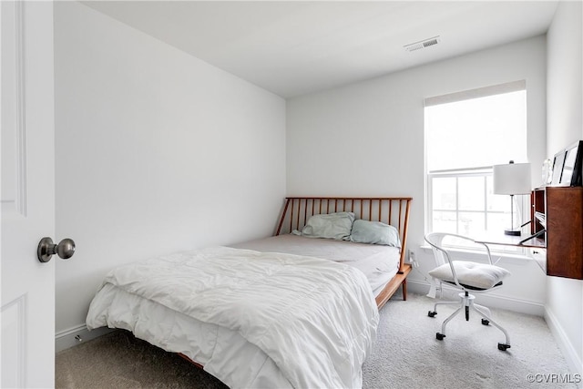 carpeted bedroom with visible vents and baseboards
