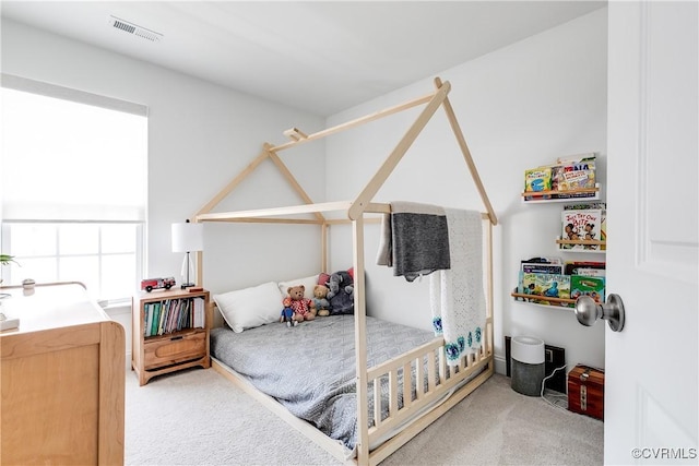 carpeted bedroom featuring visible vents