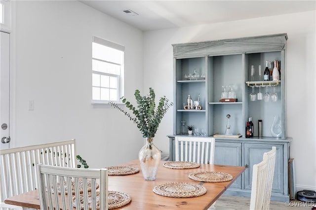 dining room with a bar and visible vents
