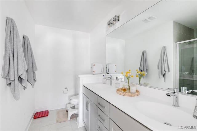 full bathroom featuring double vanity, a sink, a stall shower, and toilet