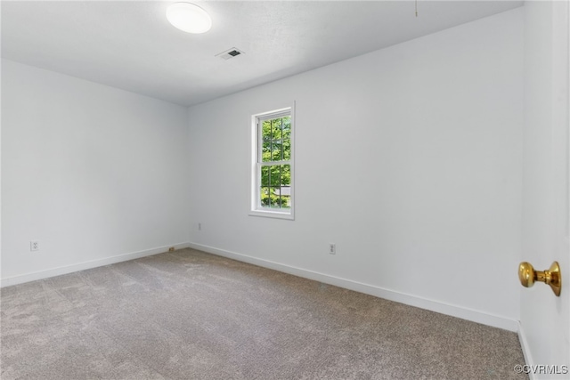 empty room with light colored carpet and baseboards