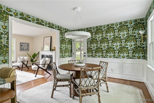 3454 Warner Rd, Richmond, VA 23225 - dining area featuring wallpapered walls, wainscoting, wood finished floors, and plenty of natural light