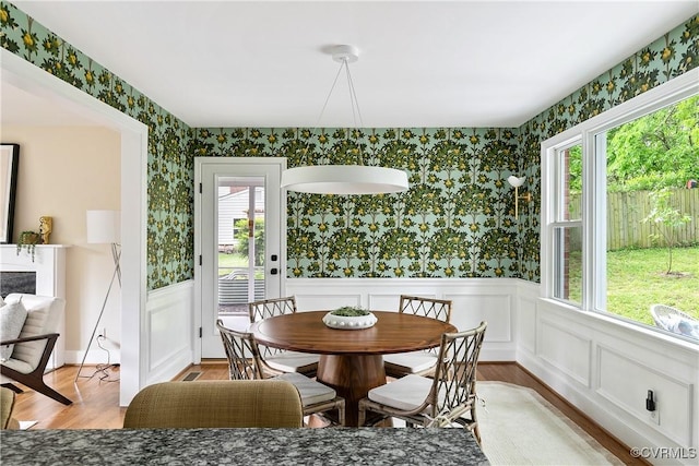 3454 Warner Rd, Richmond, VA 23225 - dining room featuring wallpapered walls, wainscoting, plenty of natural light, and light wood-style floors