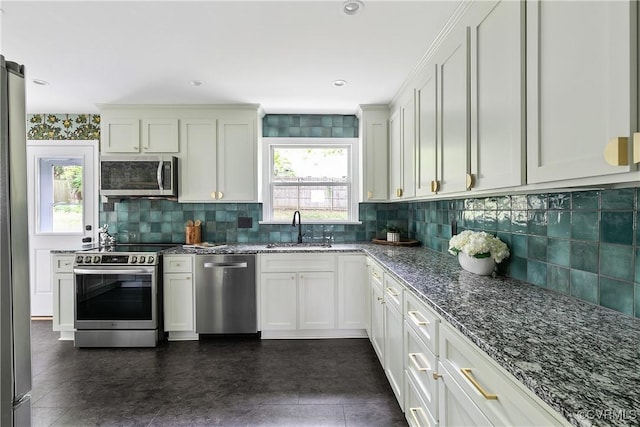 3454 Warner Rd, Richmond, VA 23225 - kitchen with appliances with stainless steel finishes, a sink, dark stone counters, backsplash, and white cabinetry