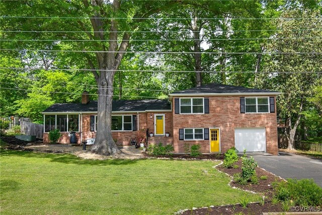 3454 Warner Rd, Richmond, VA 23225 - split level home featuring driveway, a garage, a chimney, and brick siding