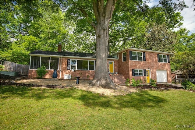 3454 Warner Rd, Richmond, VA 23225 - split level home with brick siding, a chimney, and an attached garage
