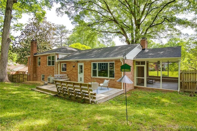 3454 Warner Rd, Richmond, VA 23225 - rear view of house with a chimney, a sunroom, a wooden deck, brick siding, and central air condition unit