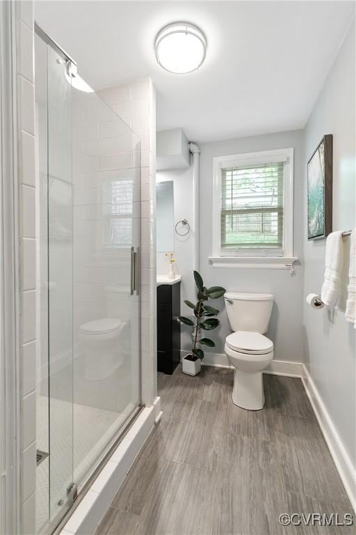 3454 Warner Rd, Richmond, VA 23225 - bathroom featuring toilet, wood finished floors, baseboards, a shower stall, and vanity