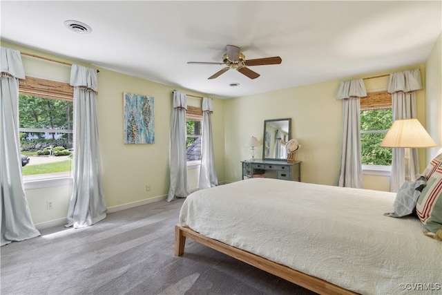 bedroom featuring baseboards, multiple windows, carpet flooring, and visible vents