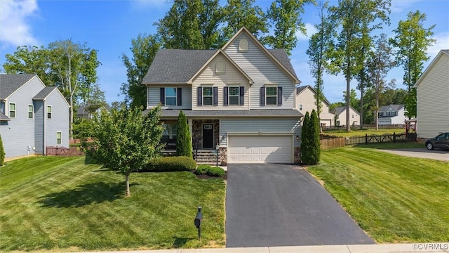 traditional home with a garage, aphalt driveway, stone siding, and a front yard