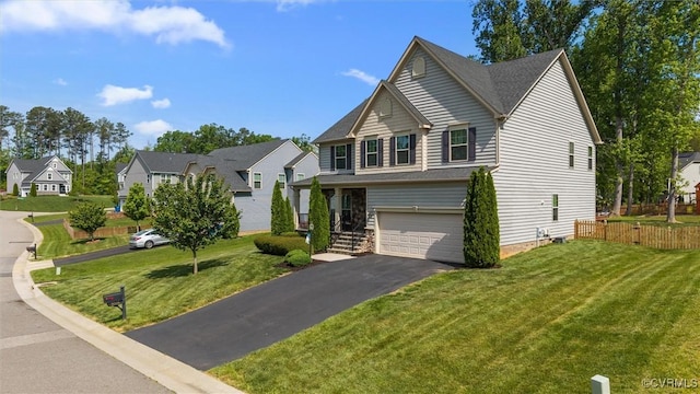 view of front facade featuring a garage, a front lawn, fence, and driveway