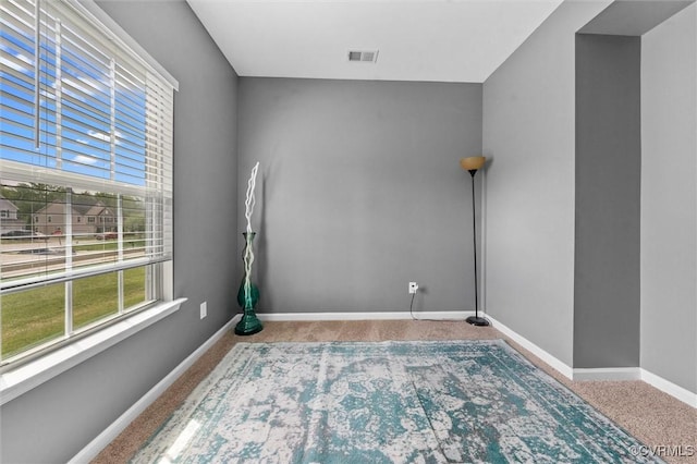 unfurnished room featuring baseboards, carpet flooring, and visible vents