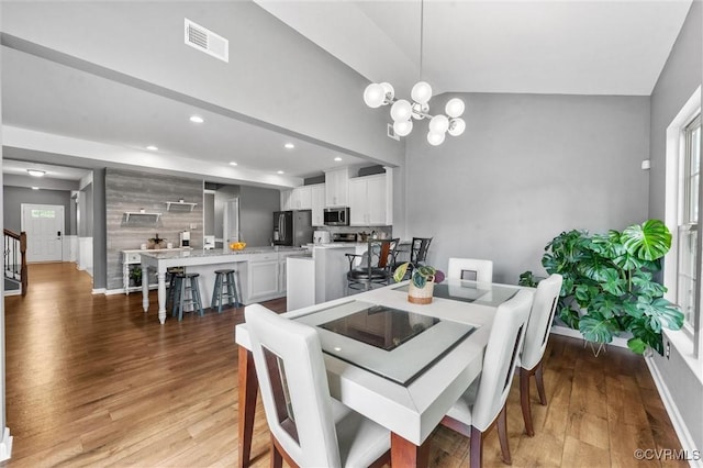 dining space with visible vents, light wood-type flooring, baseboards, a notable chandelier, and recessed lighting
