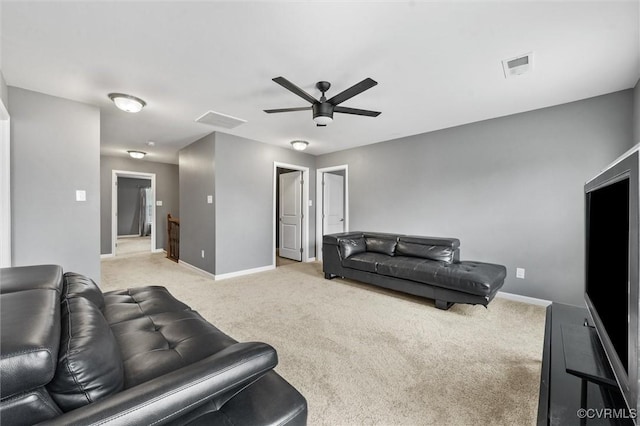 living room with baseboards, light colored carpet, and visible vents